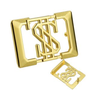 Gold-tone rectangular belt buckle with a cutout monogram, textured corners and a smaller reverse-side view.