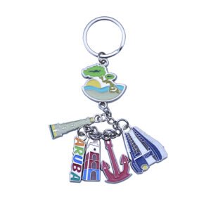 Aruba souvenir keychain with a coastal tree scene and dangling lighthouse, lettering, building, anchor and boat charms.