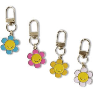 Four smiling flower enamel keychains with blue, pink, yellow and pale pink petals, yellow centers and gold-tone swivel clips.
